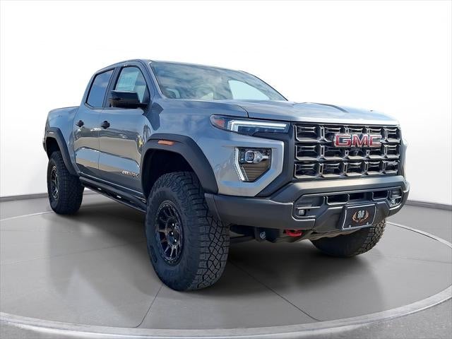 2025 GMC Canyon AT4 in Sterling Metallic — front three-quarter view
