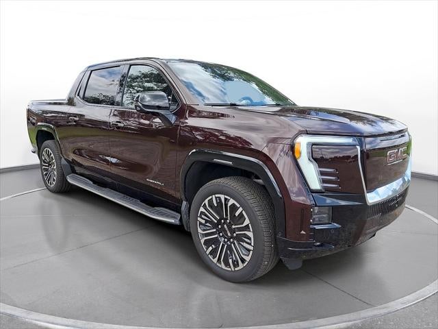2026 GMC Sierra EV Denali Extended Range in Dark Ember Metallic — front three-quarter view