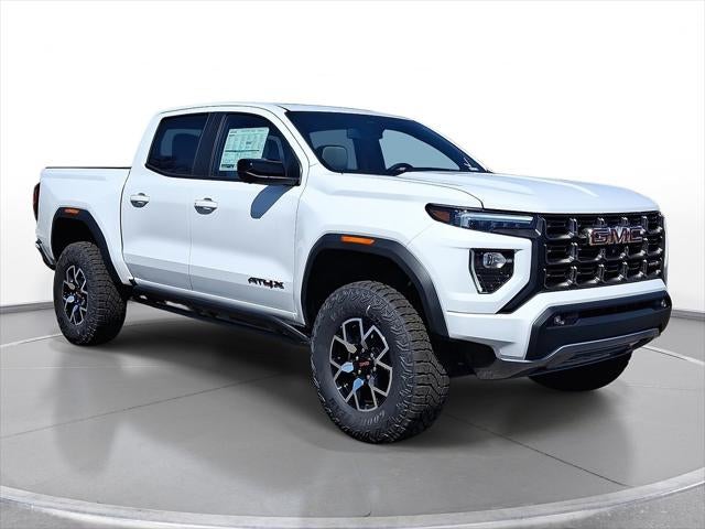 2025 GMC Canyon AT4 in Summit White — front three-quarter view